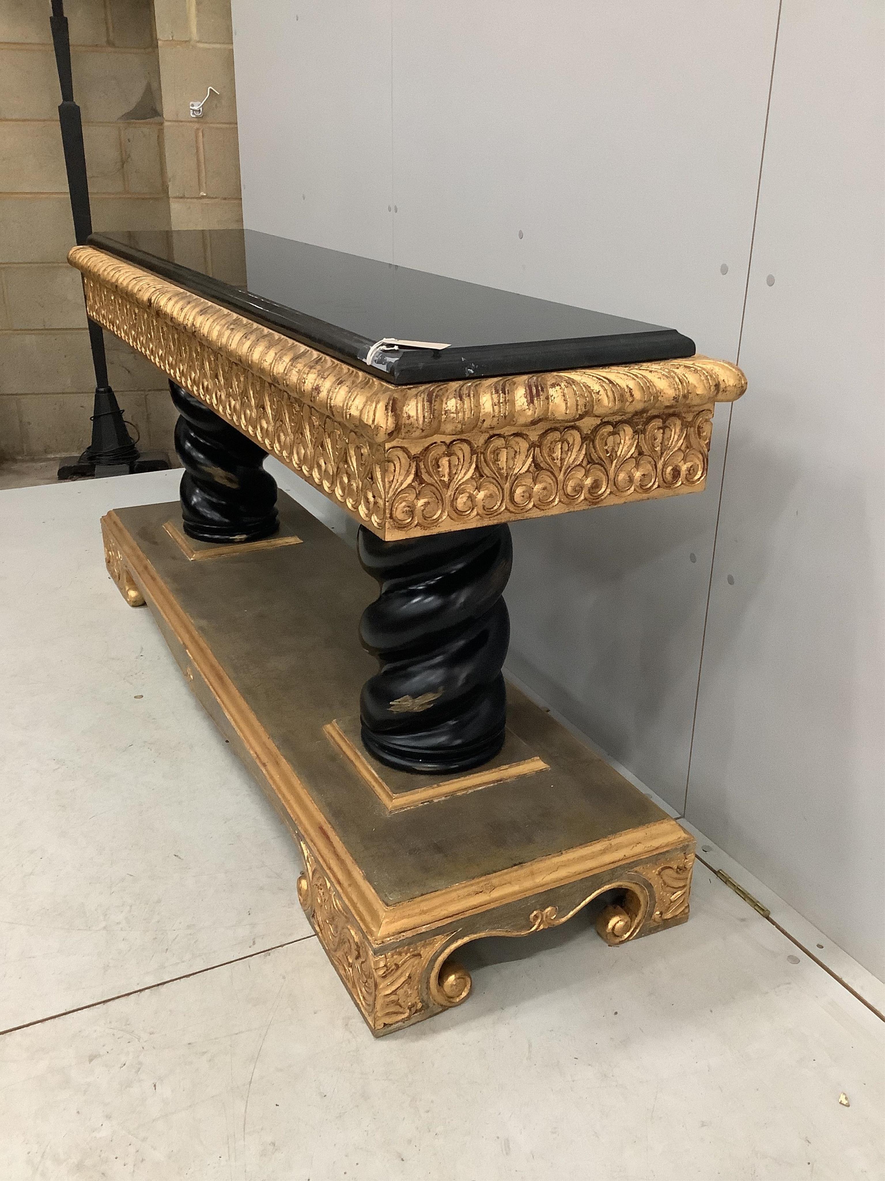 A Harrison Gil parcel gilt console table with marble inset top, width 180cm, depth 51cm, height 85cm and matching ornate wall mirror, width 138cm, height 165cm. Condition - fair to good, some minor chipping